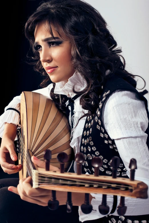 the girl is holding an instrument and playing