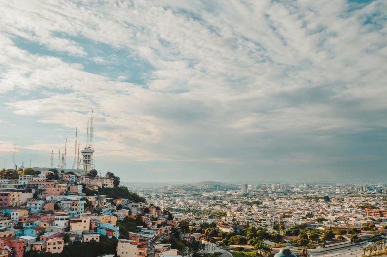 view from a hill, over a city under cloudy skies