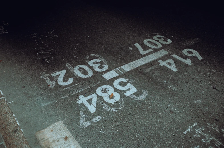 a street sign for rue louis, rue l'avop is in white paint on the ground