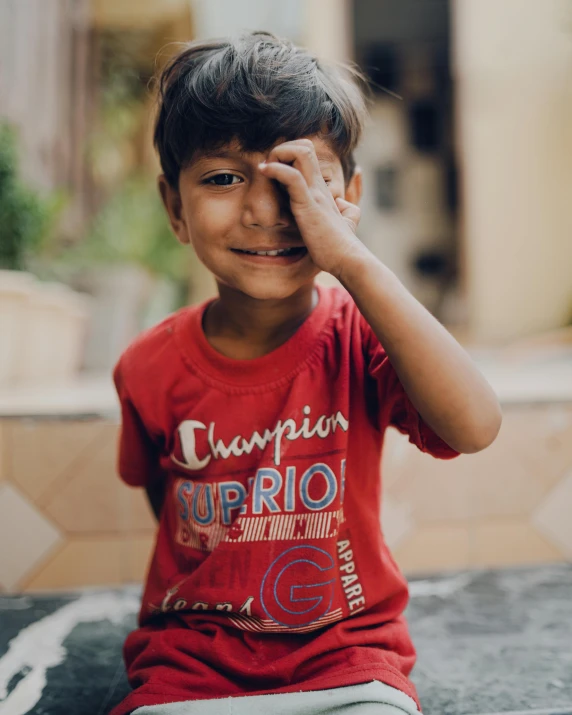 a  who has one eye closed holds his head in a gesture