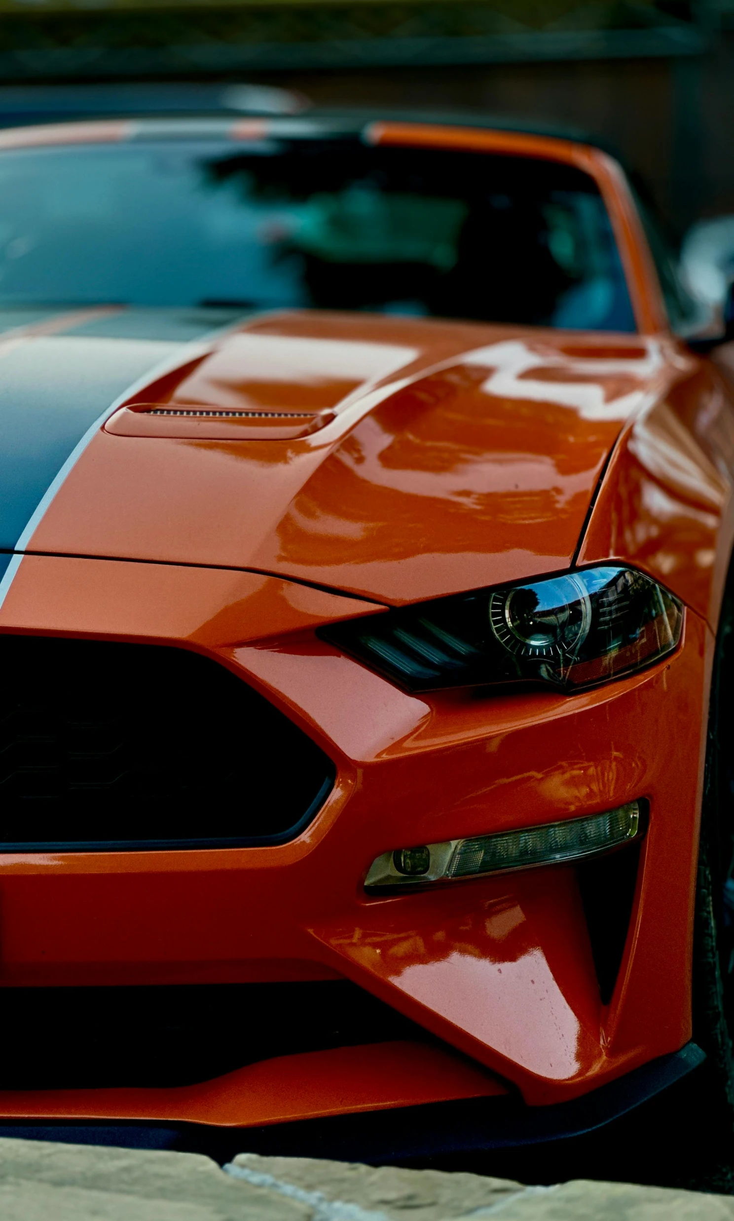 orange mustang sports car, parked on street corner