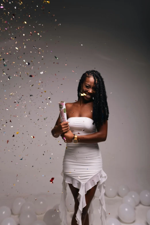 an image of a woman posing with confetti and balloons