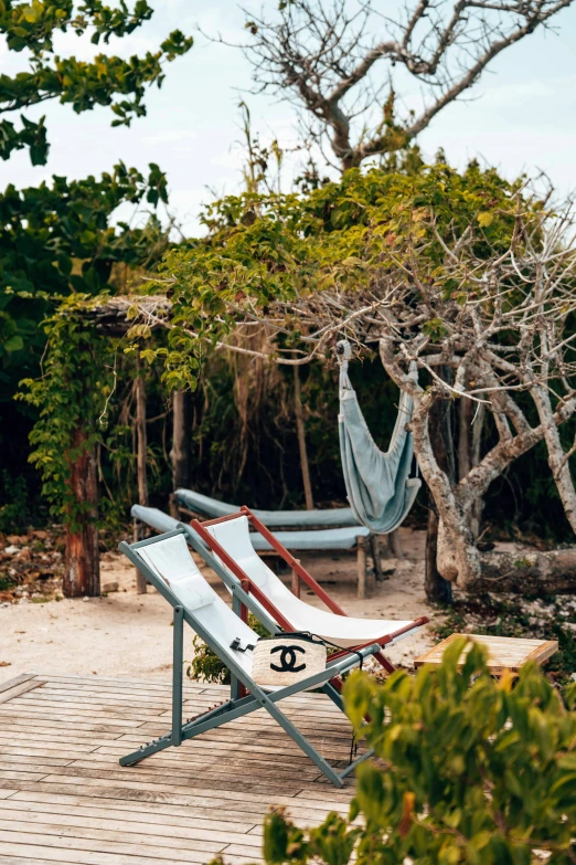 two striped chairs on a white brick patio