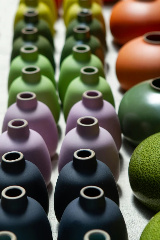 a close up of several different colored vases