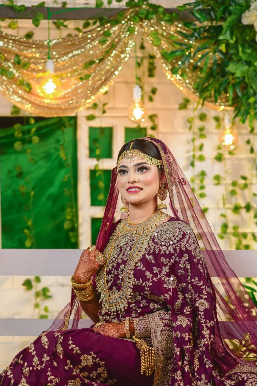 a smiling woman dressed in an indian wedding outfit