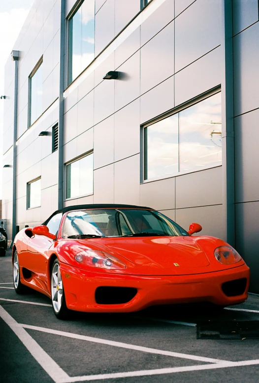 a red car sits in front of a building