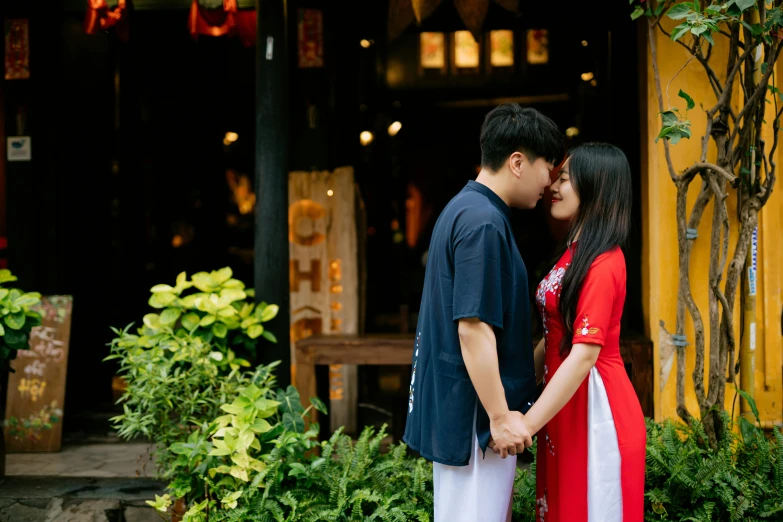 a couple standing together near some trees