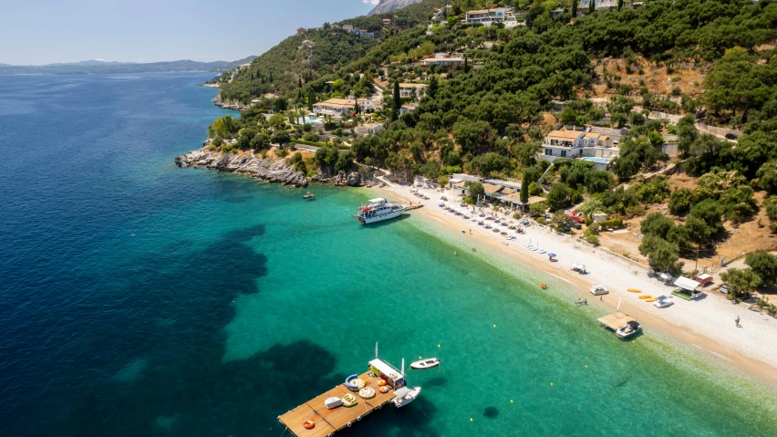 some boats are on some clear water and the beach is clean