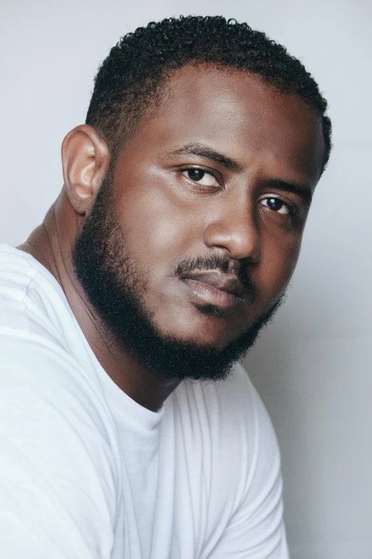 a close - up s of a black man posing for the camera