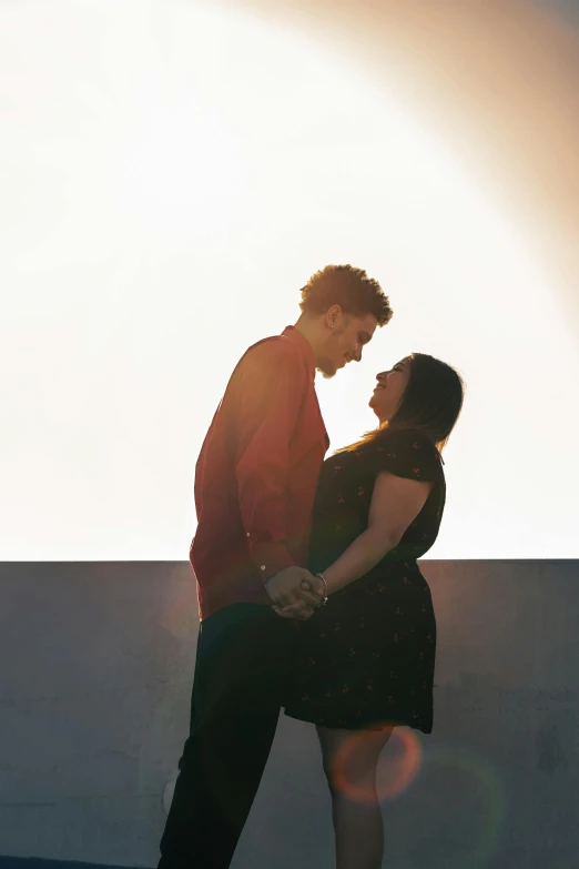 a young man and woman standing close together