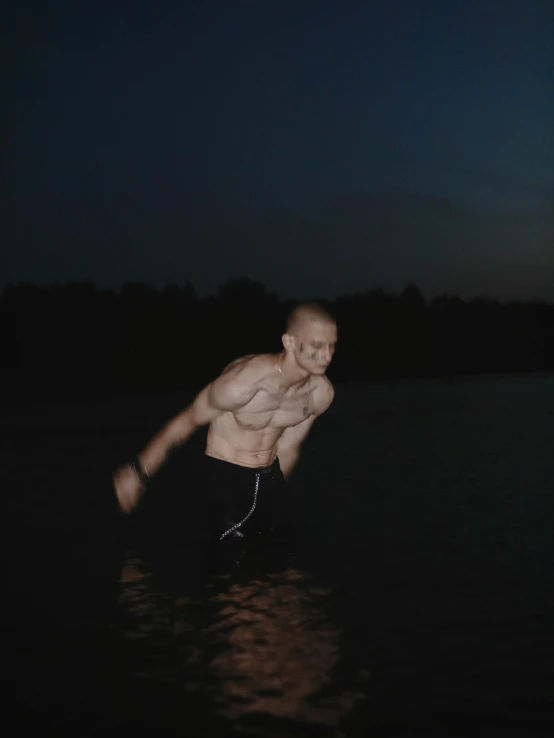 a young man is standing in the water