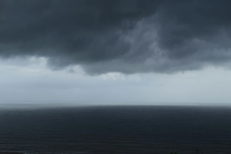 a very big long body of water with some big clouds