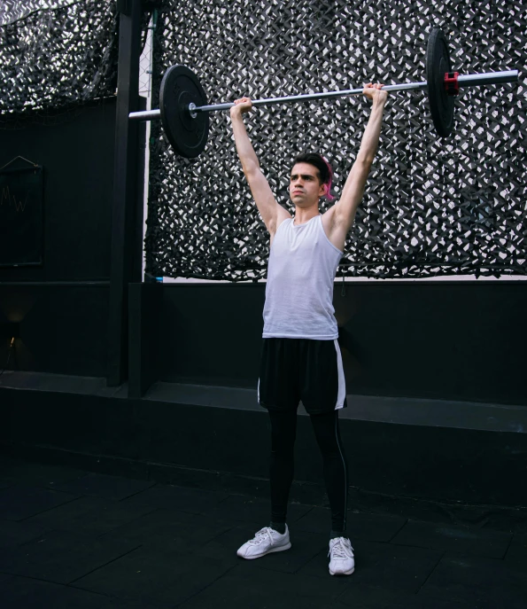 a person who is holding some kind of barbell