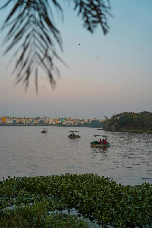 some small boats with people in them on the water