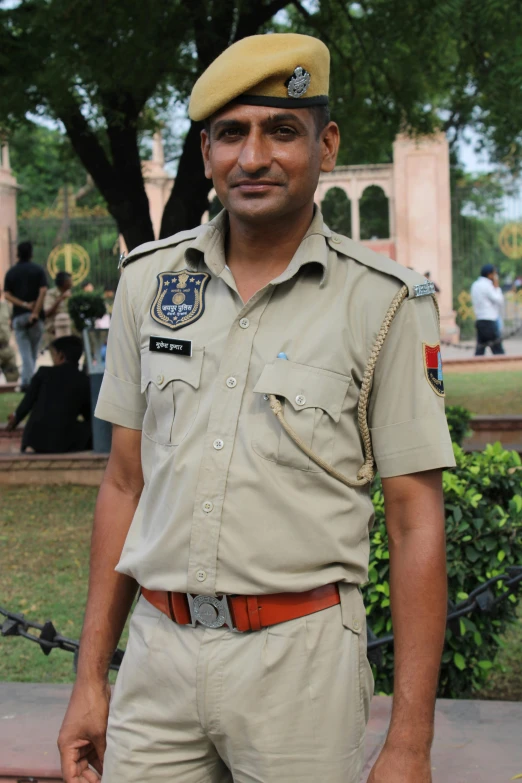 the man in the uniform of a policeman is smiling