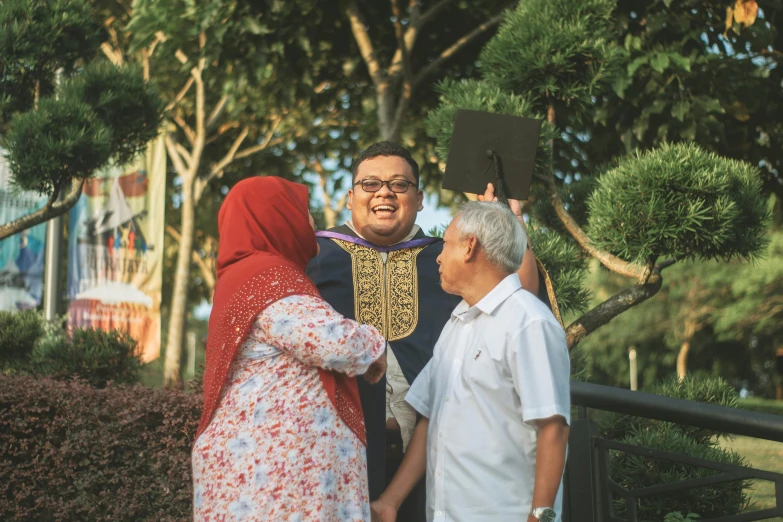 two men and a woman are standing near a man