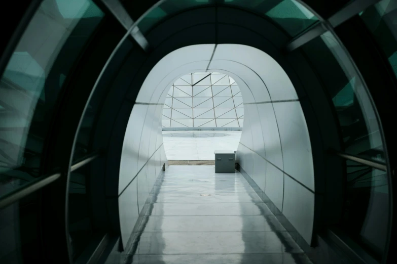 an empty walkway in a building with green light