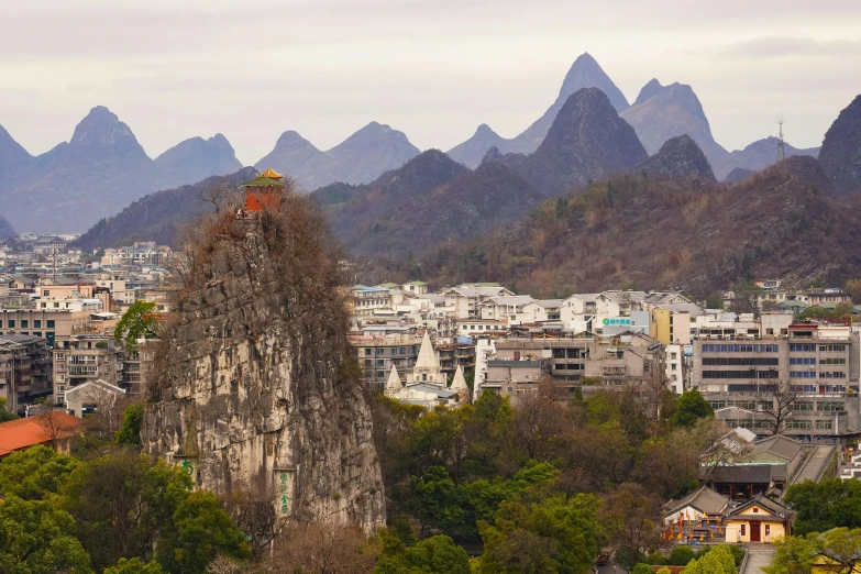 the buildings on the hill have people climbing up them