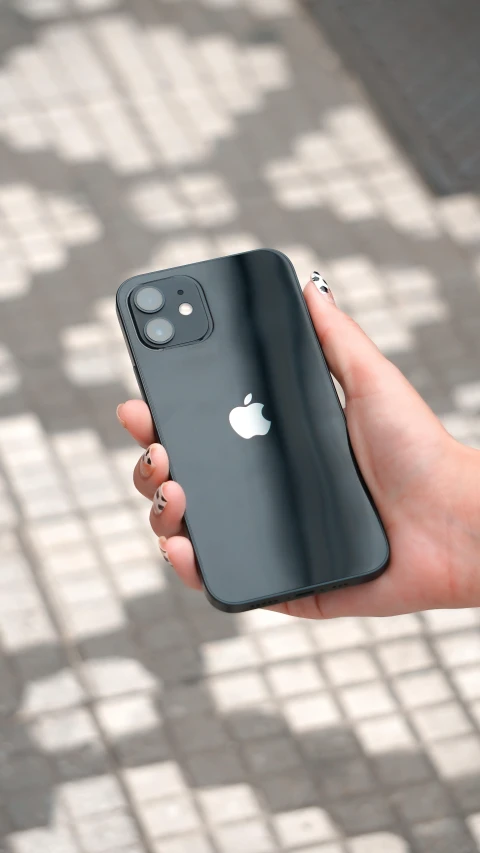 a hand holding a phone in front of the camera