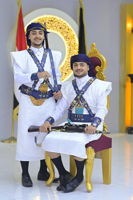 two men dressed in white outfits and holding guns