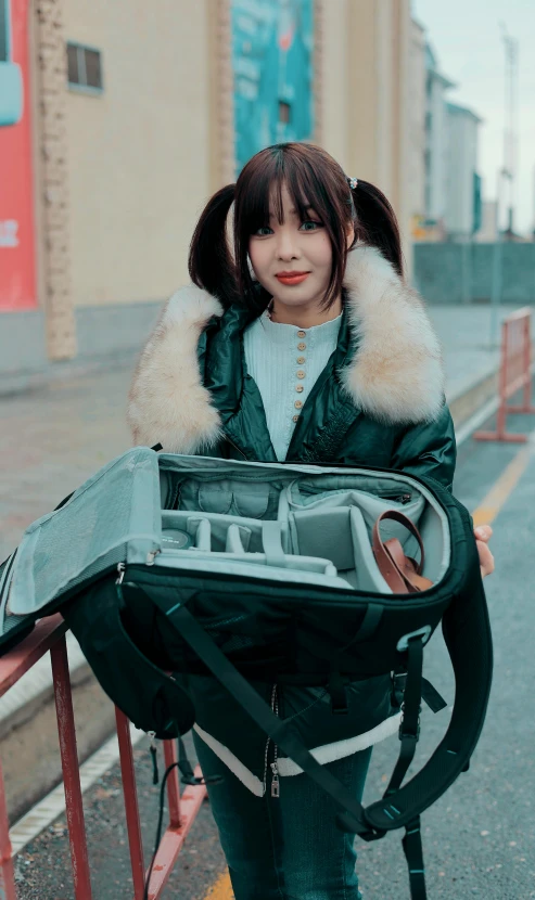 a woman carrying a suitcase with earplugs to her ear