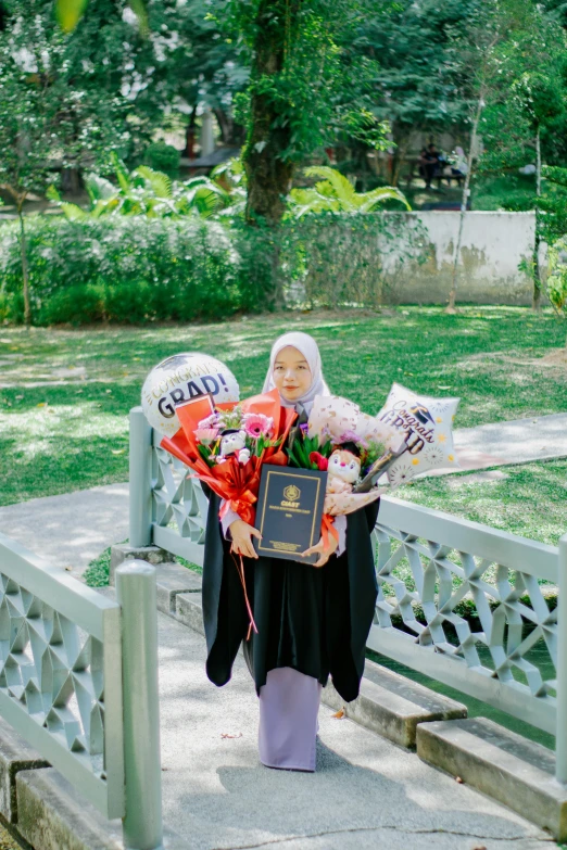 woman with teddy bears, flowers and flowers is holding her memorial plaque