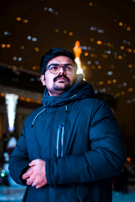 a man with a beard and glasses looking off into the distance