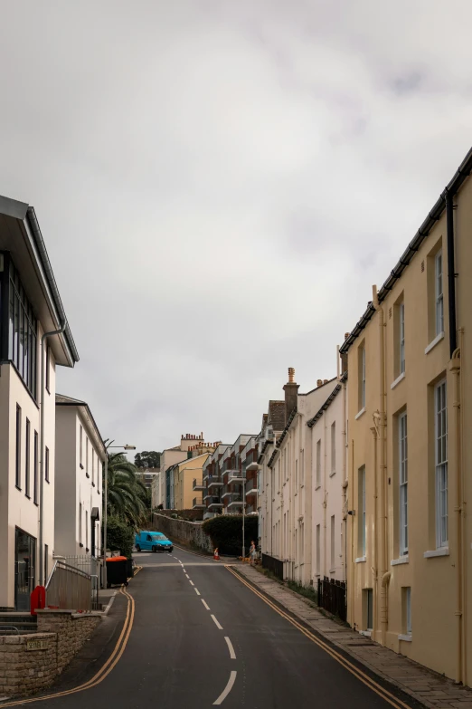 the street in front of some buildings is empty