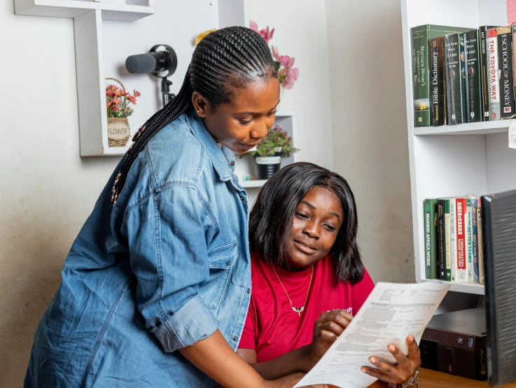 a couple of women that are looking at some paper