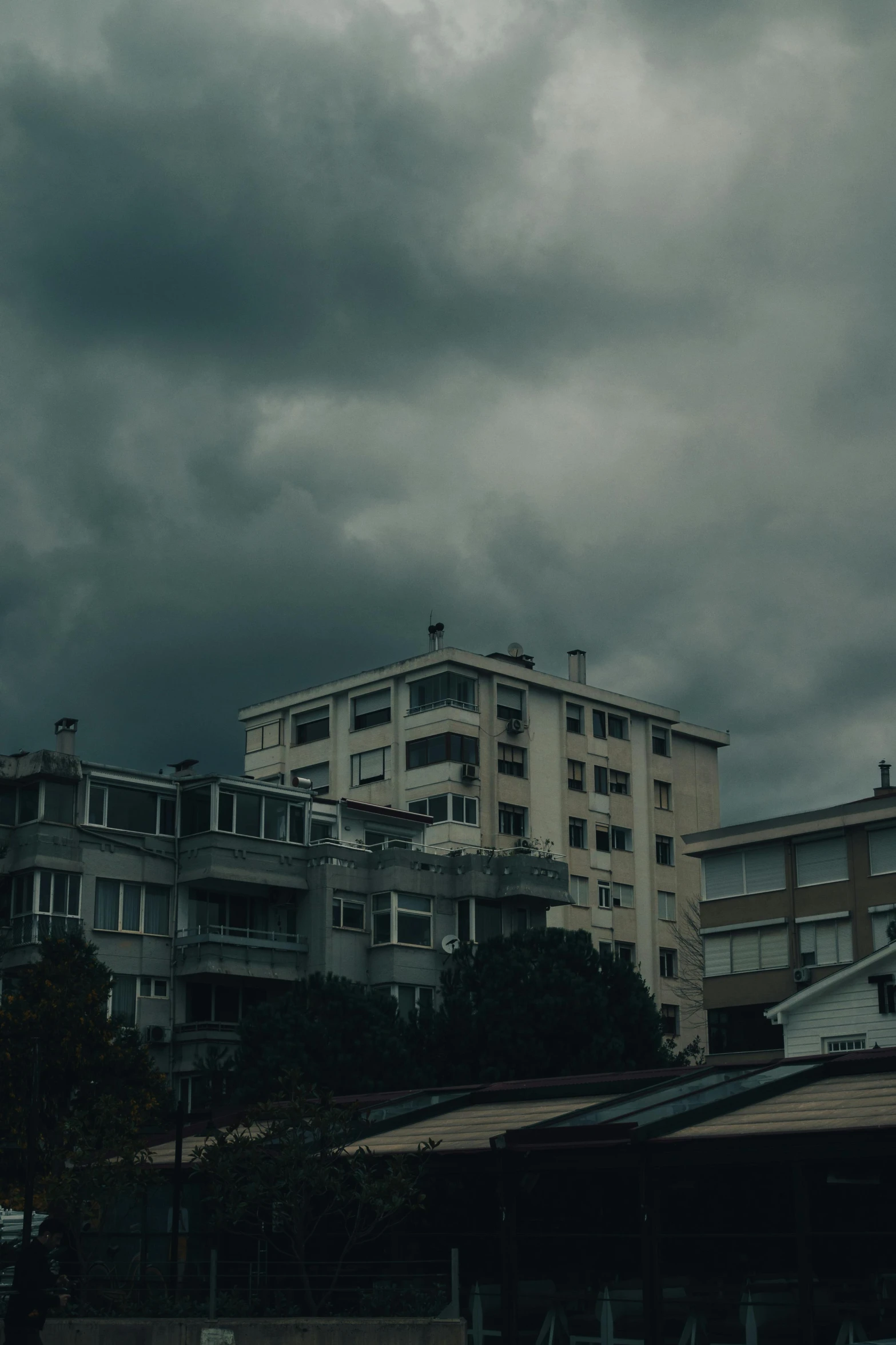 storm clouds loom over two apartment buildings