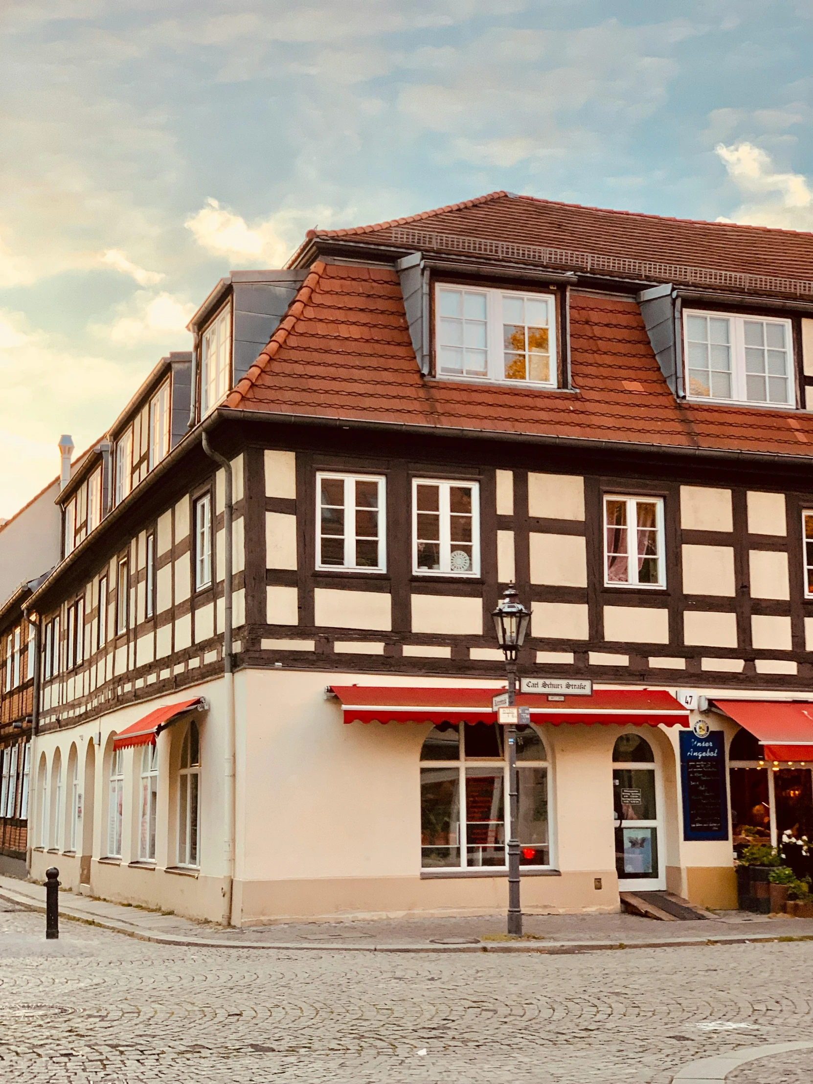 two old houses with white windows and red roof tops