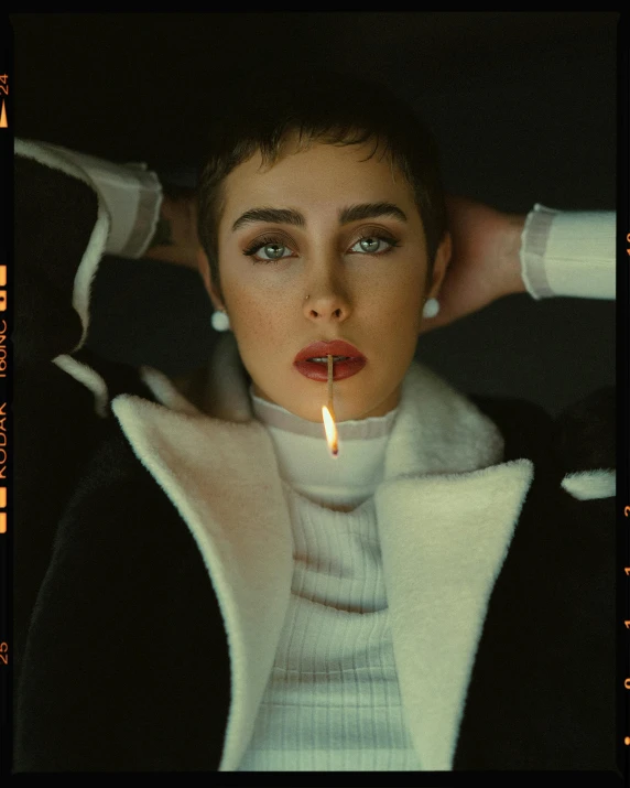 a woman in a white sweater putting a cigarette