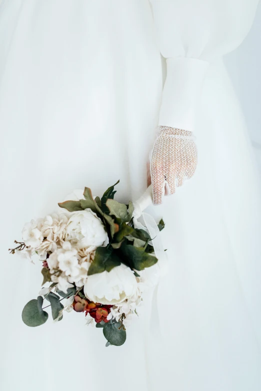 bouquet on the floor with white fabric with lace