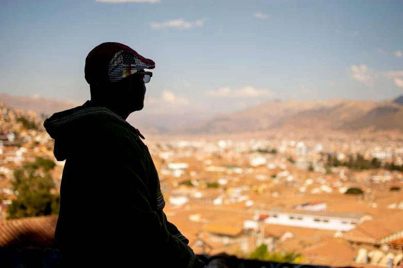 a person standing on a hill overlooking a city