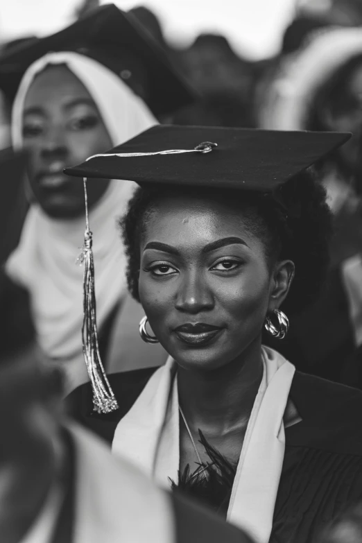 a woman in graduation cap and gown smiling