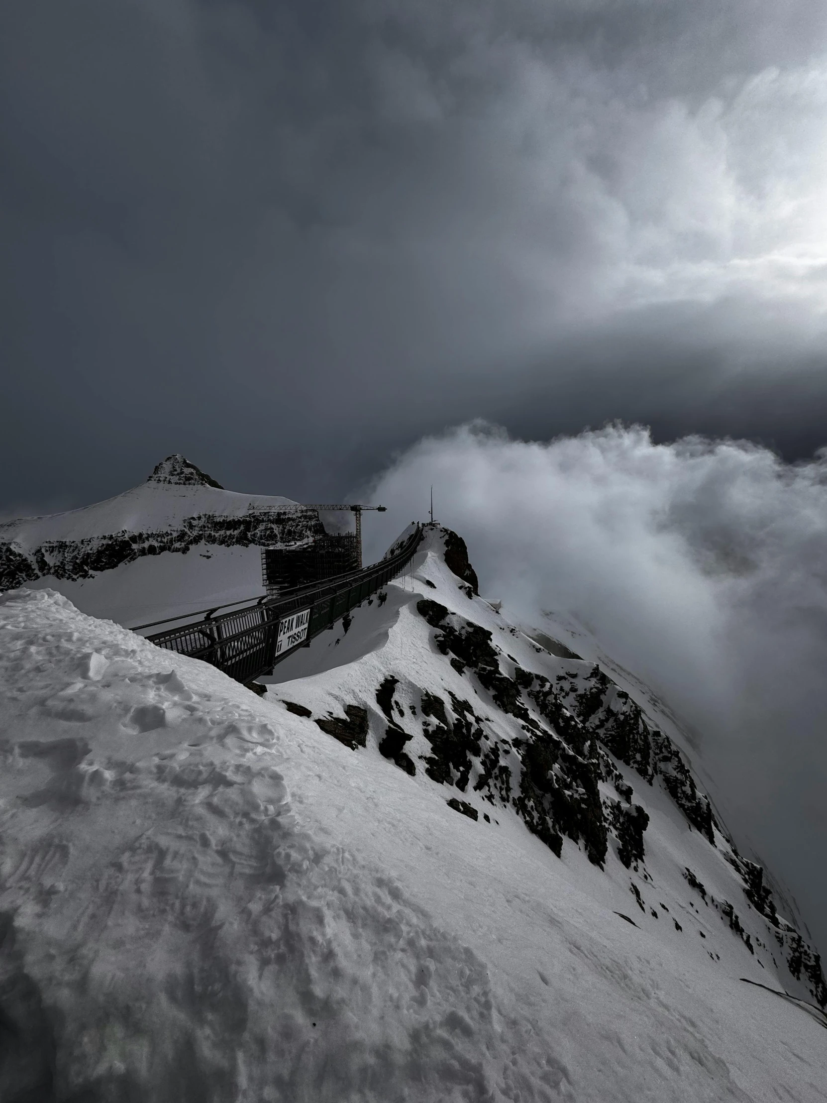 a snowboarder is standing on a snow covered mountain