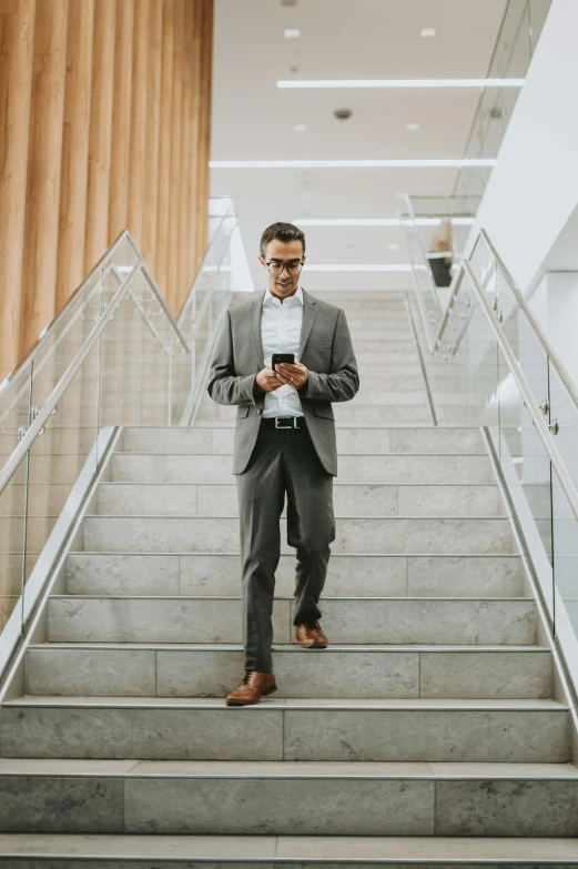 a man wearing glasses using his cell phone