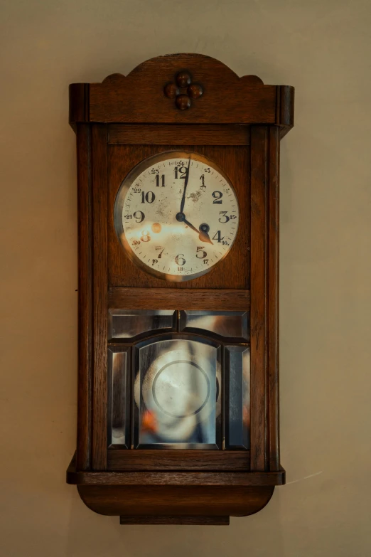 a clock hanging on a wall that is lit up