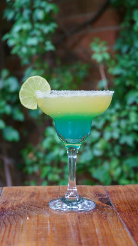 a margarita cocktail with lime, lemon wedge and sugar