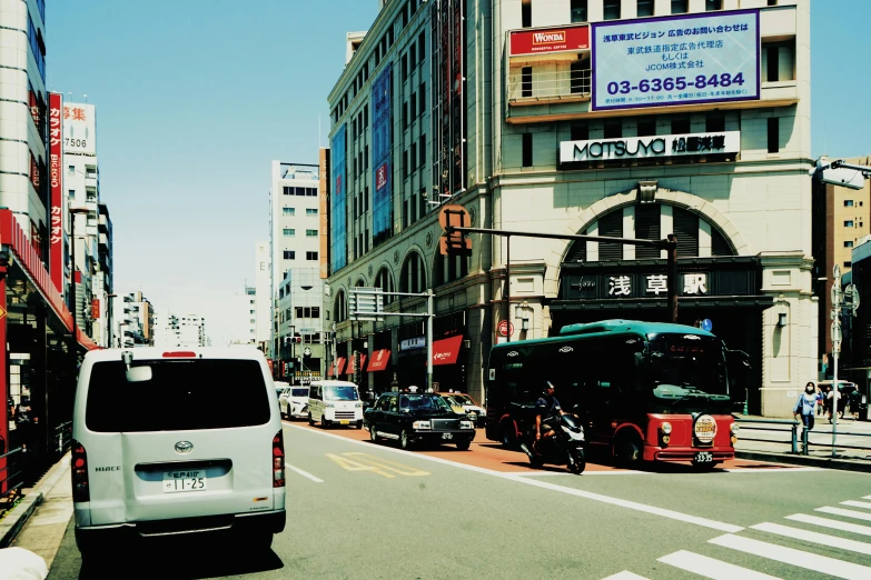 an asian - style city street with tall buildings