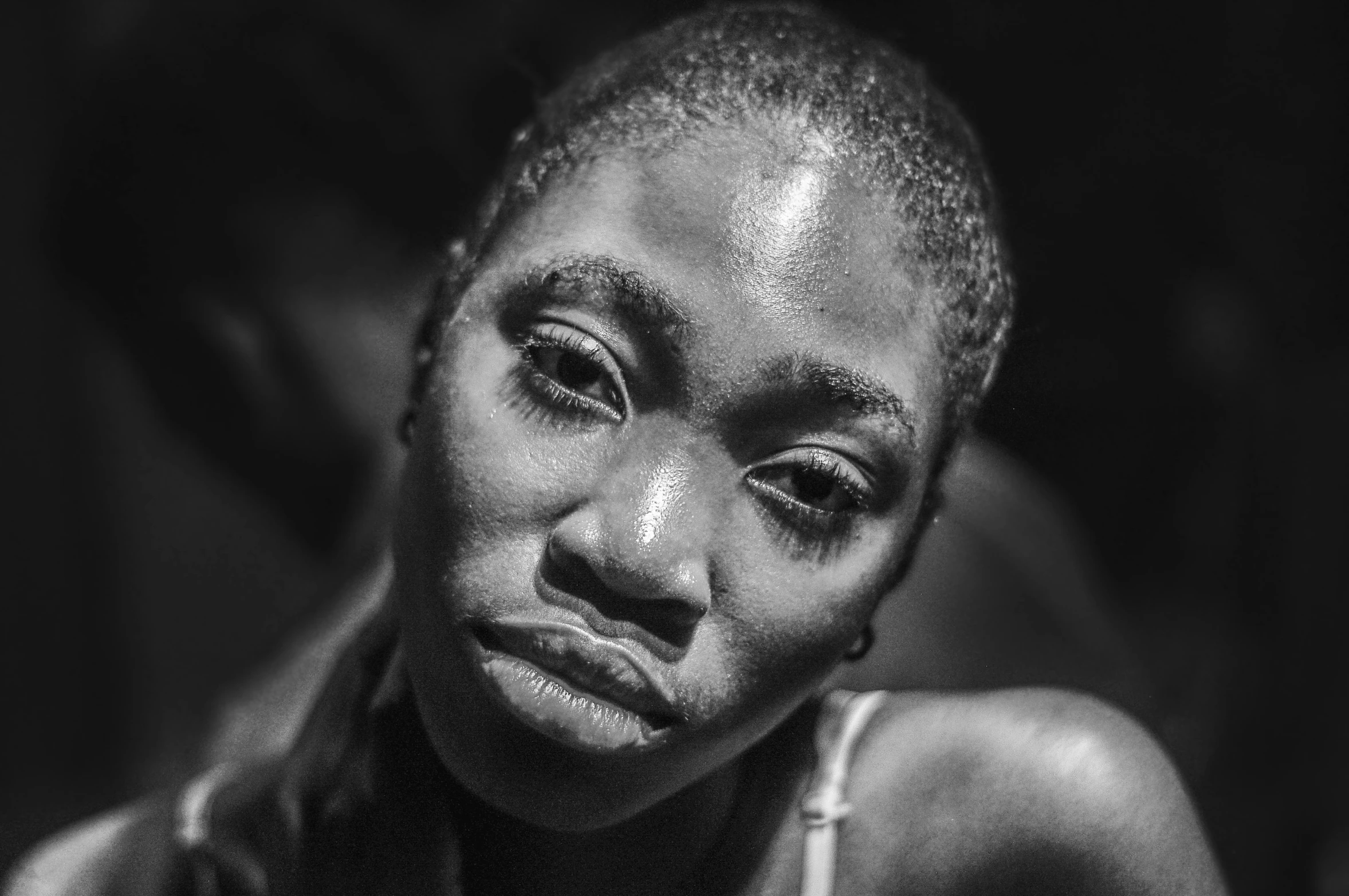 a young woman in front of a mirror crying