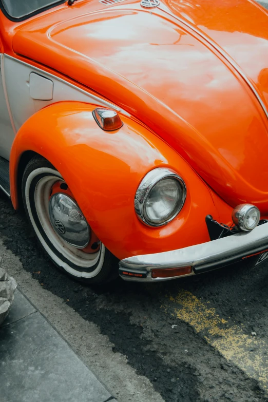 a close up view of an old car in bright orange