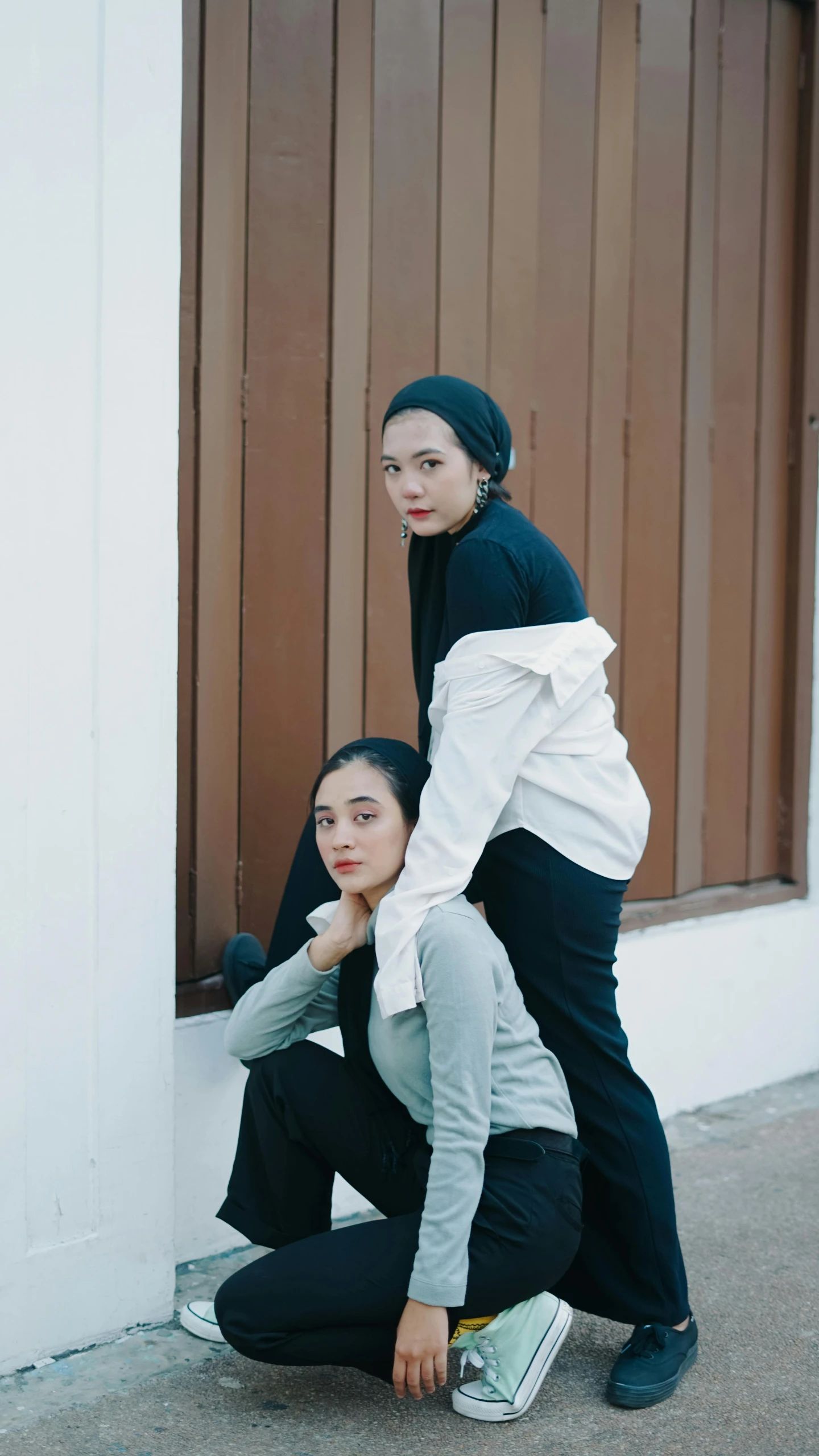 two women kneeling down next to each other