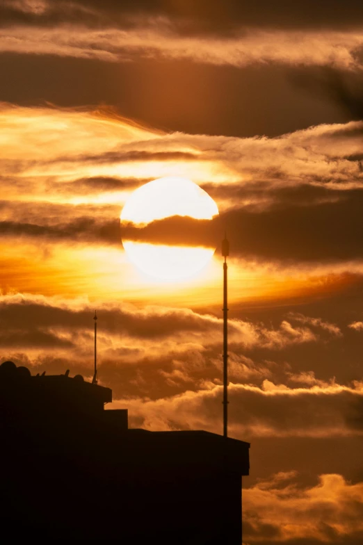 the sun peeking through the clouds in the background