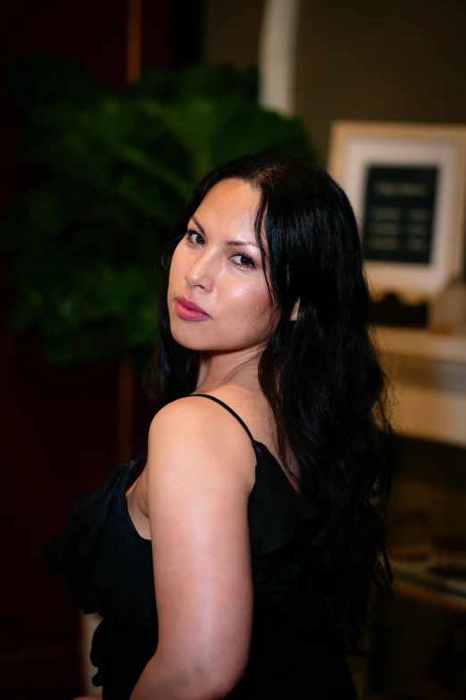 a young woman with long hair wearing a black top