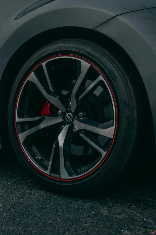 a black sports car with red spokes