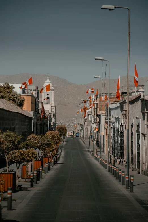 there is a road with many flags lined up on it