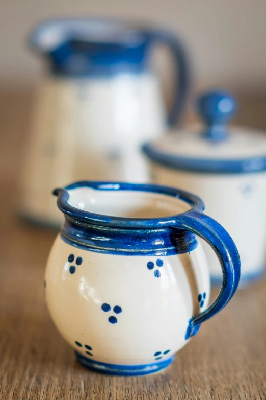 two little ceramic pitchers on a table