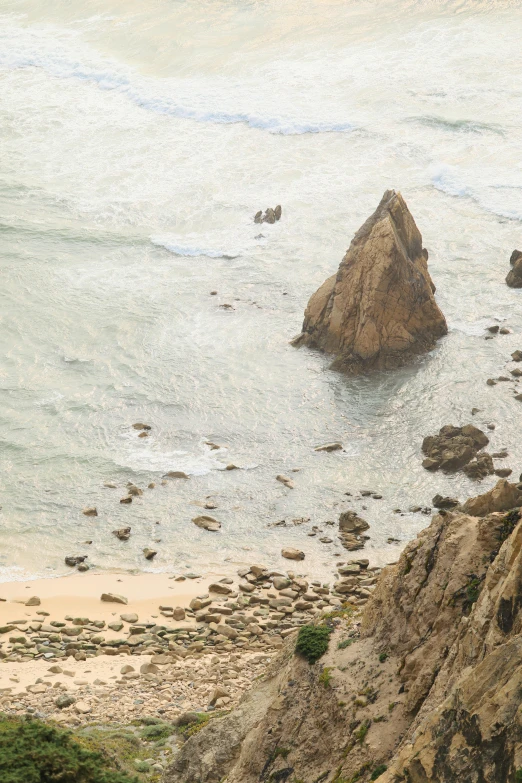 a rocky coastline near the ocean and beach