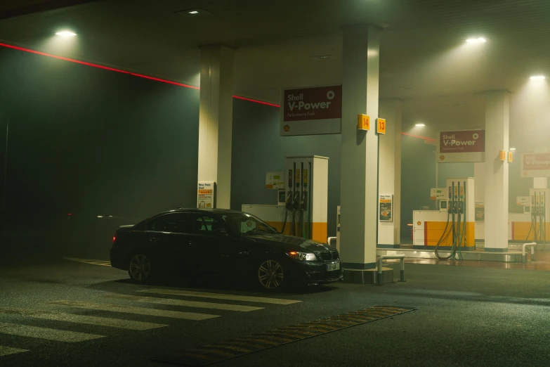 a car parked at the gas station at night